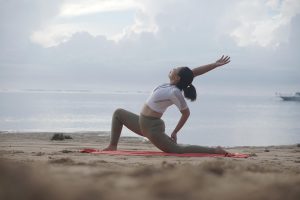 Yoga, woman, beach — Stepper Exercising Units - Professionals and Downsides